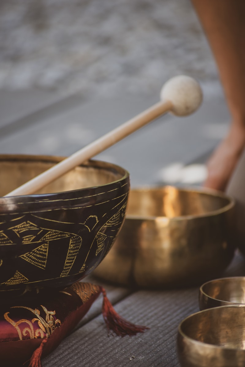 Singing sound bowls with mallet and brass bowls used in holistic healing sessions